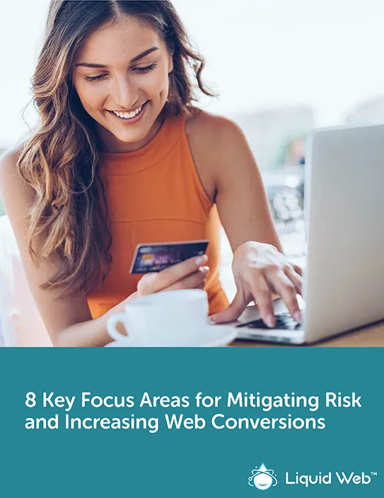 Young professional women in orange tank top smiling while online shopping and holding her credit card