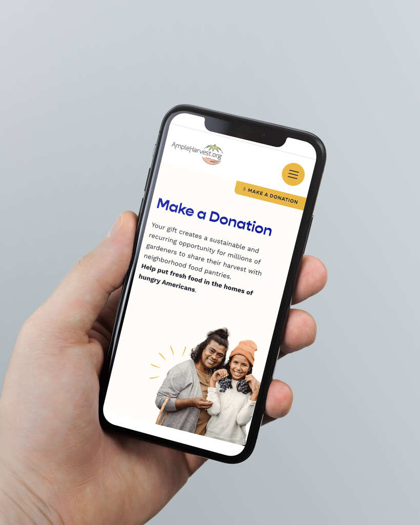 a hand holding a cell phone shows ampleharvest.org donation website