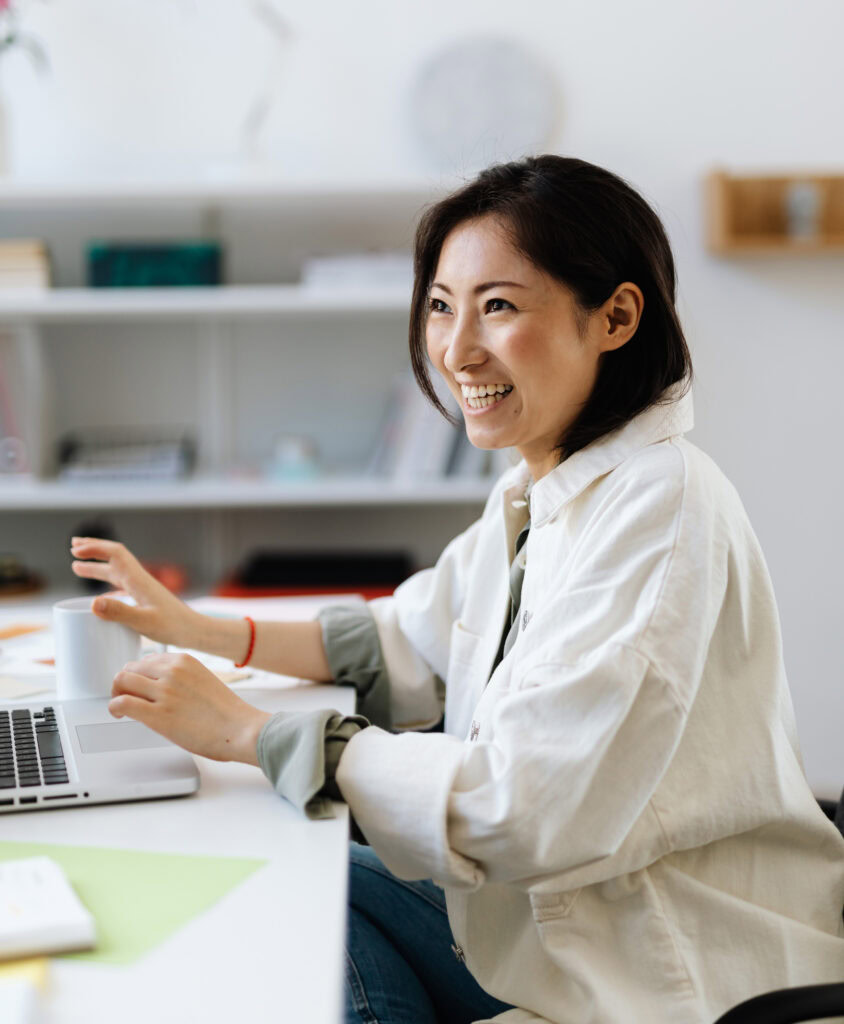Customer support agent laughing with coworker ready to help customers with problems