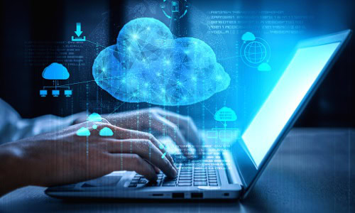 Fingers type on a laptop where the legacy to cloud migration process is shown