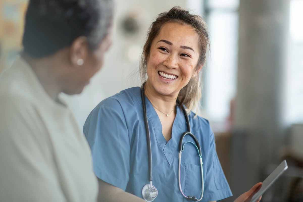 Woman in scrubs choosing a HIPAA-compliant database provider.
