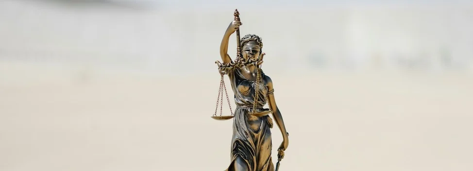Lady Justice brass statue with scales symbolizing law firm web hosting