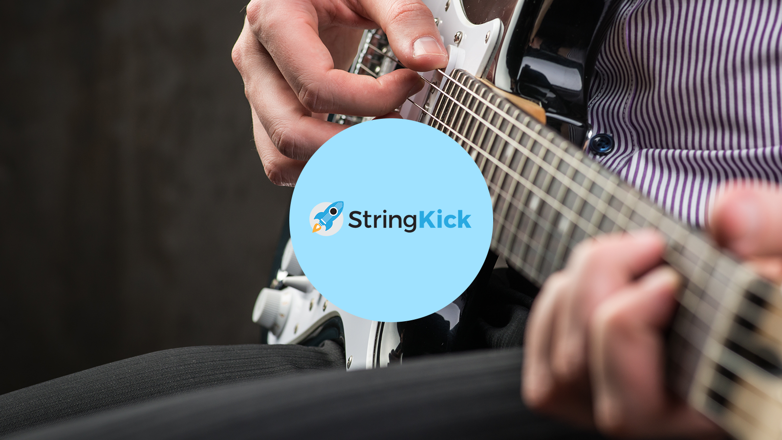A person's hands are visible, strumming on a guitar