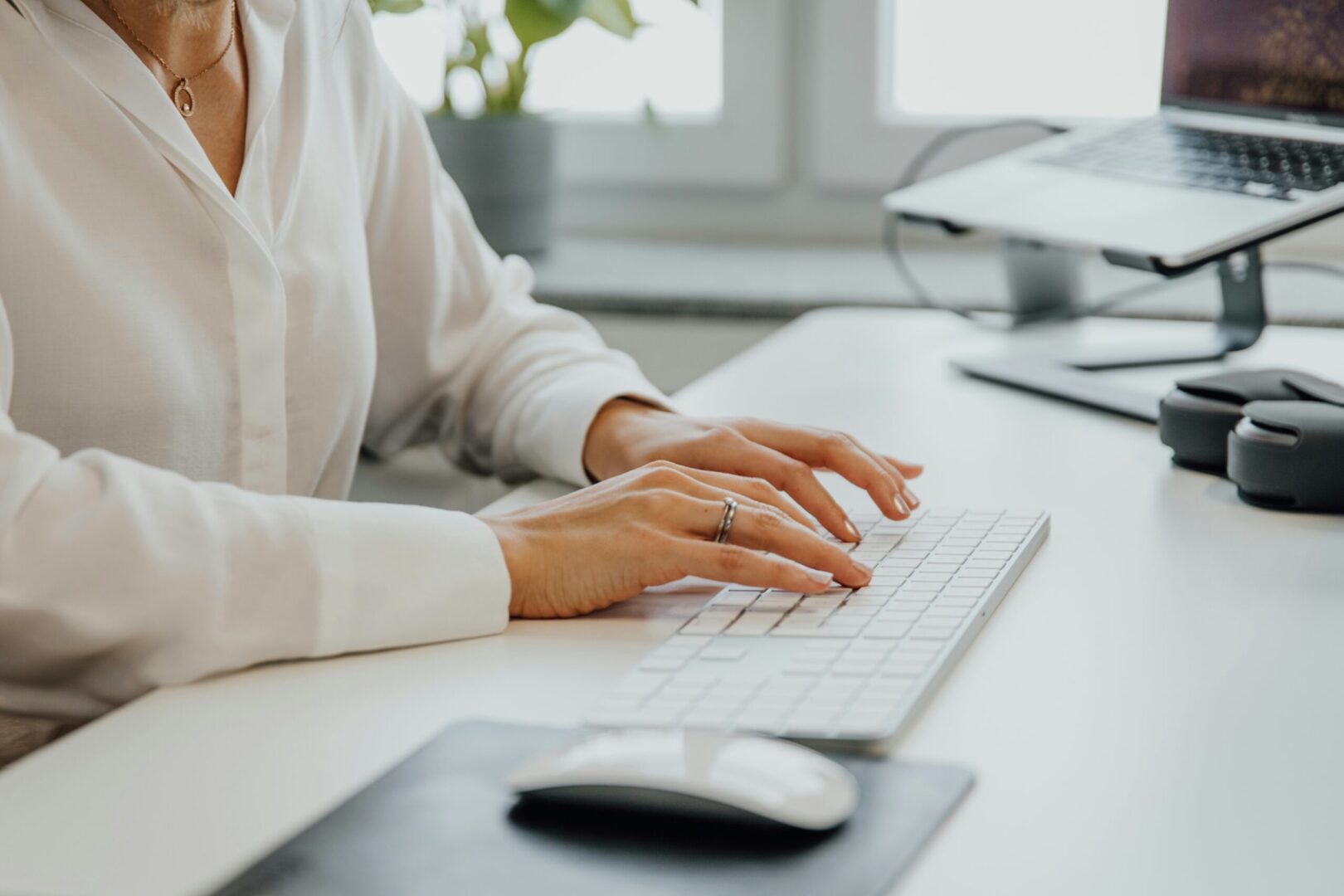 person typing on keyboard on a desk